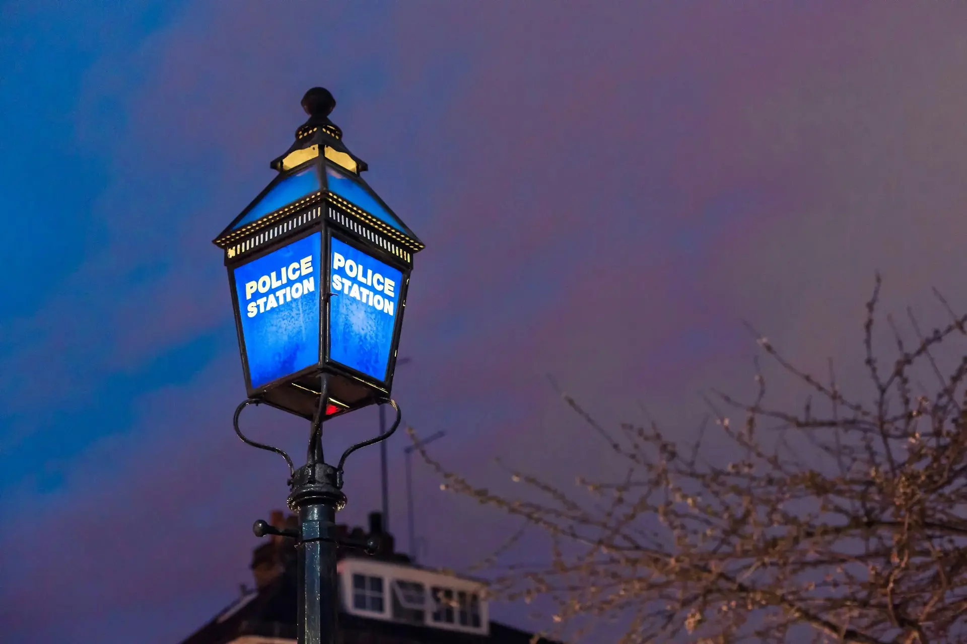 a street light with a blue light on top of it